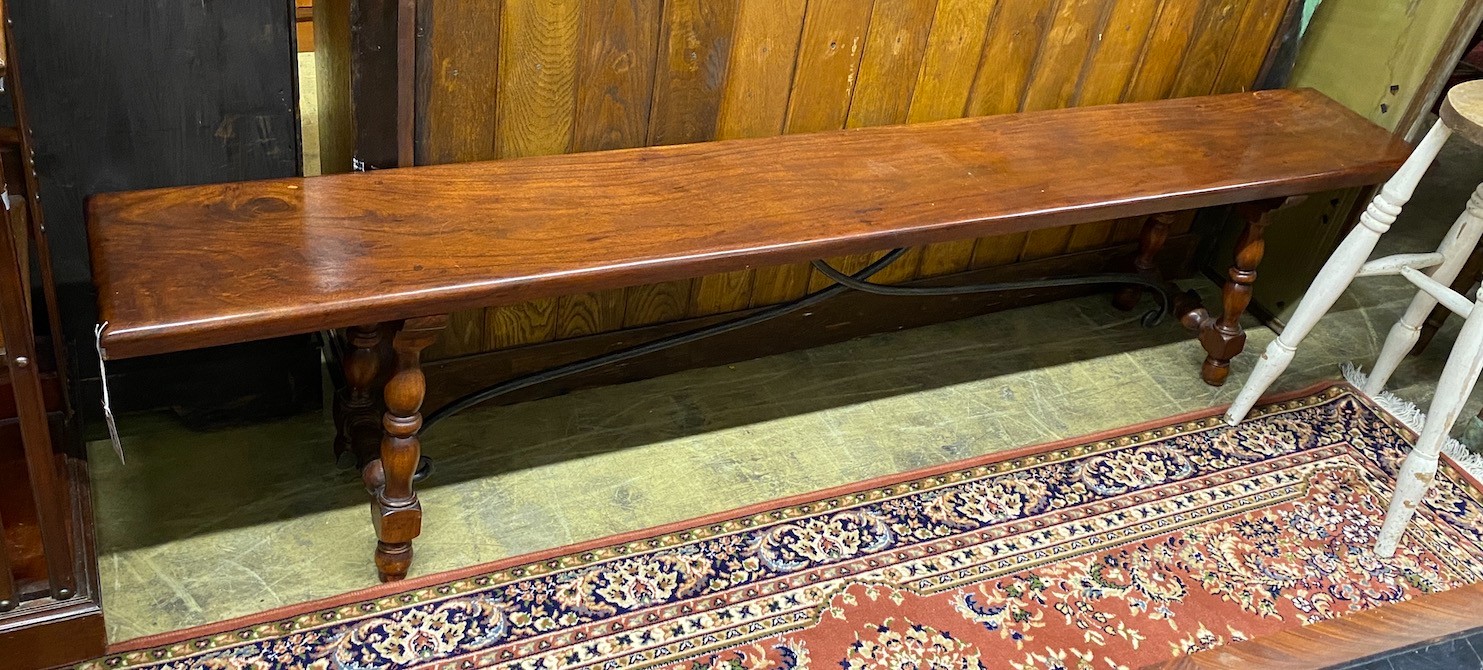 An 18th century style Italian design hardwood bench with wrought iron stretcher, length 213cm, depth 30cm, height 47cm